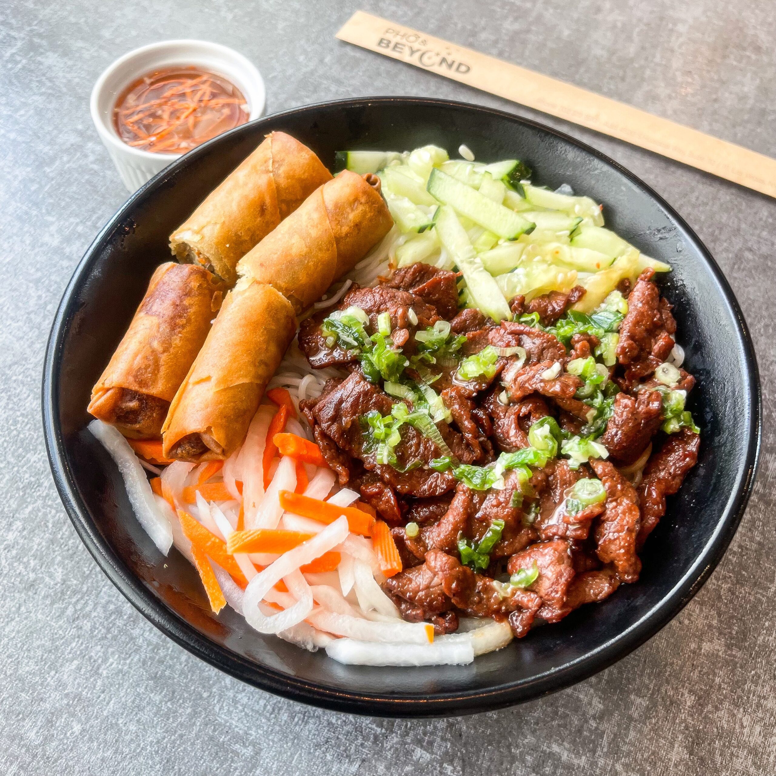 Rice vermicelli noodles with grilled meat and egg roll. Served on a bed of fresh seasonal vegetables.